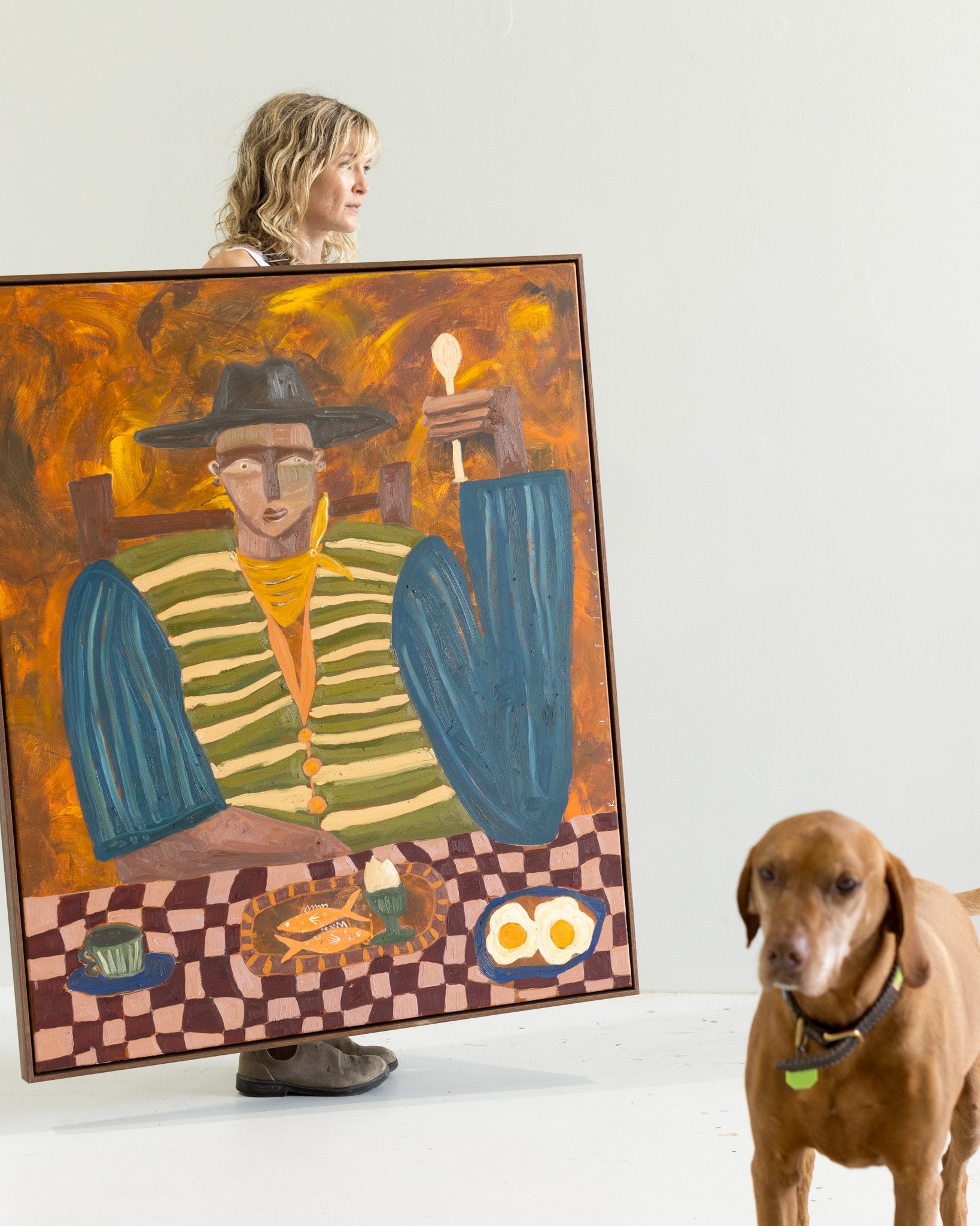 Framed artwork by Kate Florence of a person eating a nostalgic meal with a checkered tablecloth in a minimalistic room.