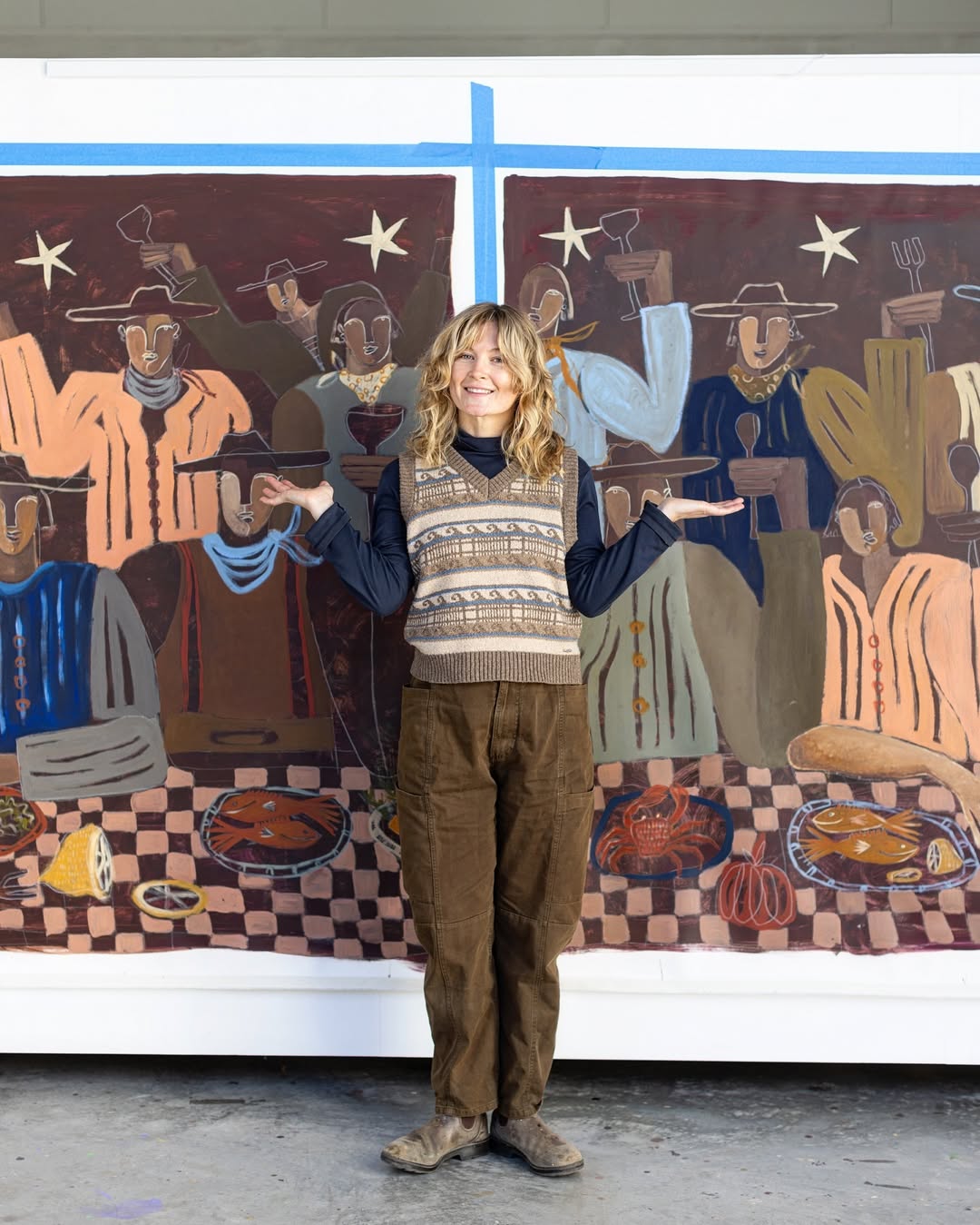 Original artwork with earthy, warm tones of a group of people with a checkered tablecloth gathering around sharing a meal.