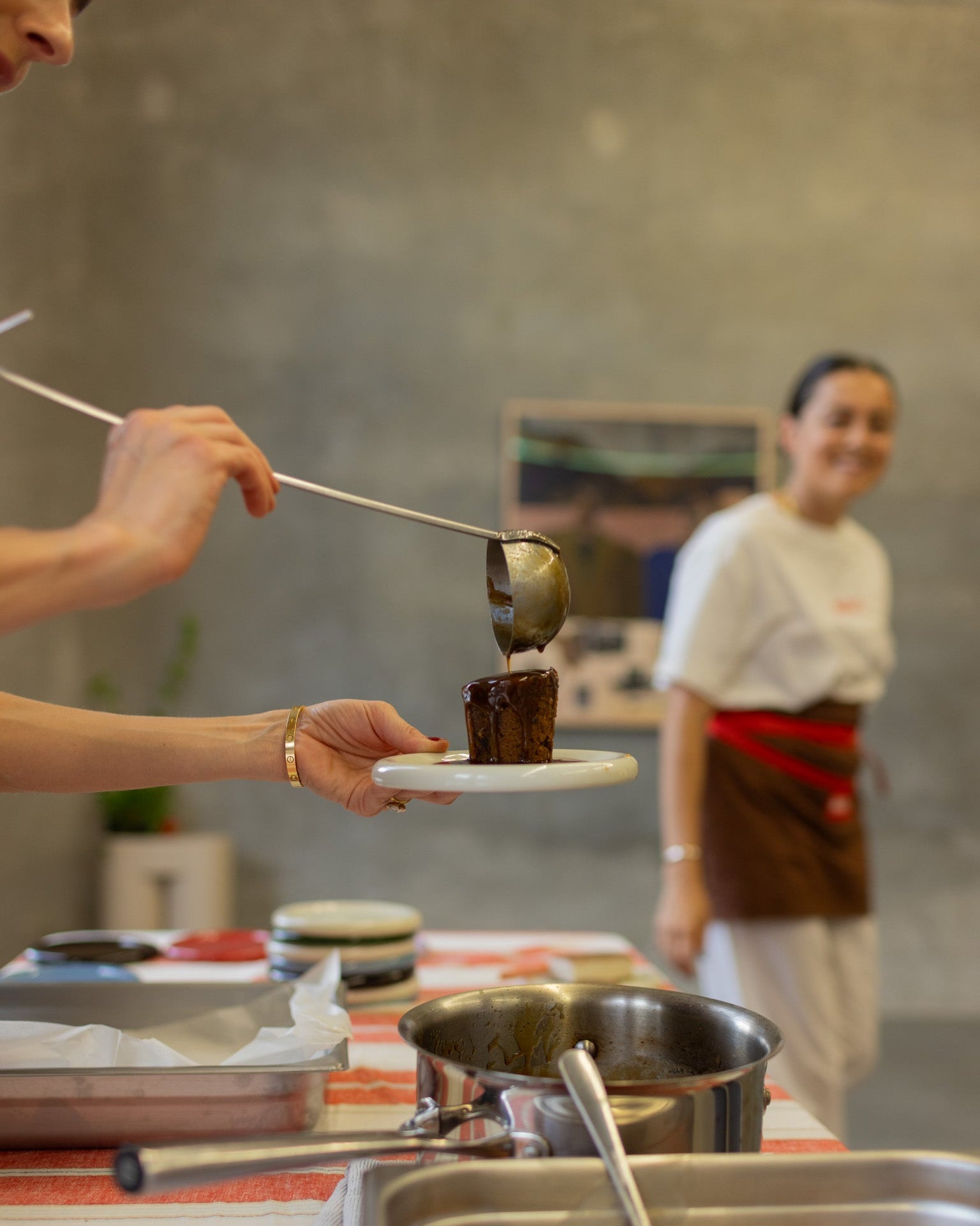 Maria's Byron Bay serving dessert with a spoon on Softedge Studio ceramic plate at Kate Florence print release event